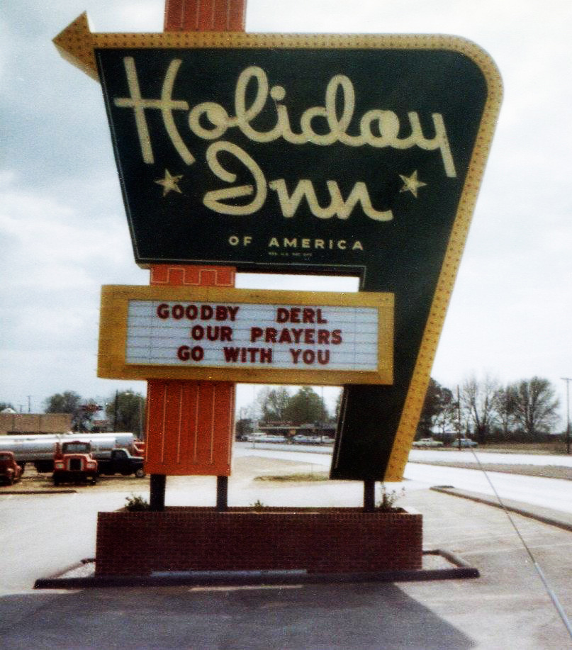 A Holiday Inn marquee sign reading GOODBY DERL OUR PRAYERS GO WITH YOU